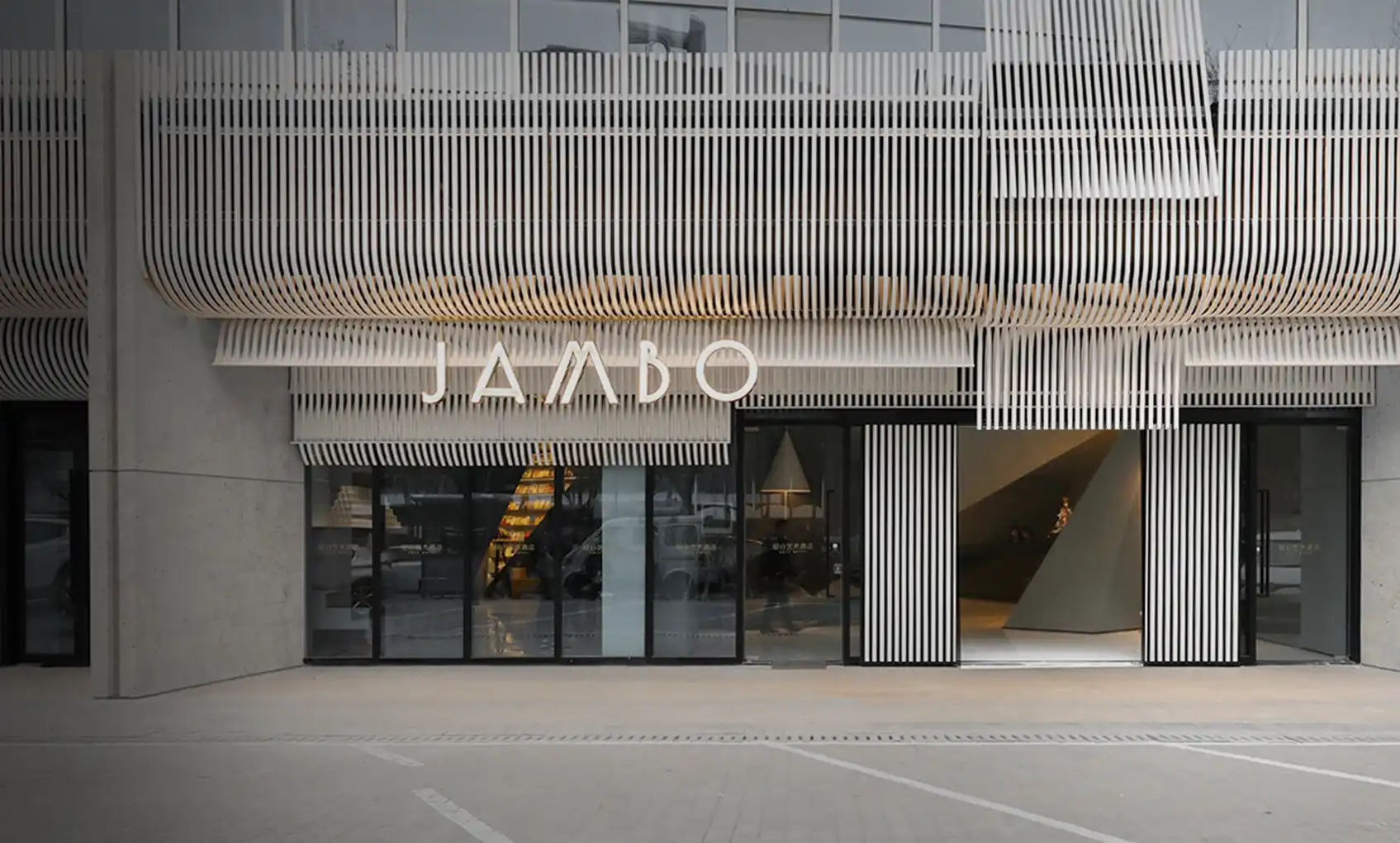 Modern architectural facade design featuring vertical parametric louvers, minimalist commercial entrance, and contemporary exterior detailing.